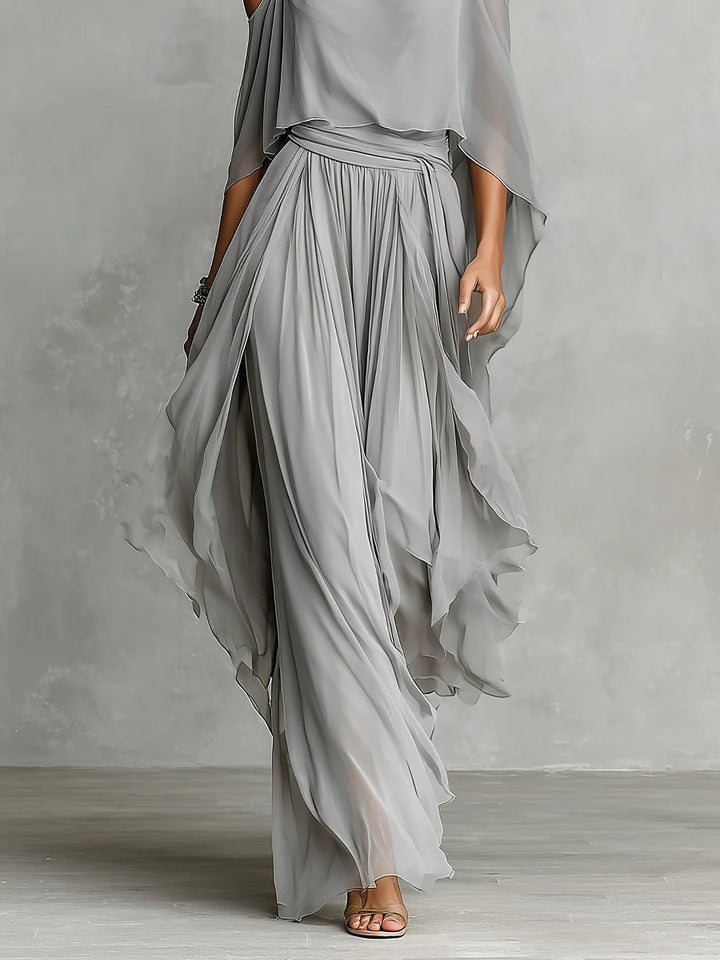 Set in grey chiffon with a fluid tank top and off-the-shoulder trousers